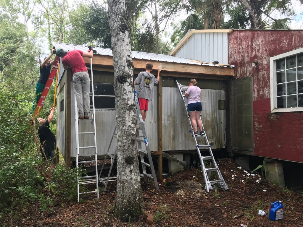 Volunteers repairing a veteran's home