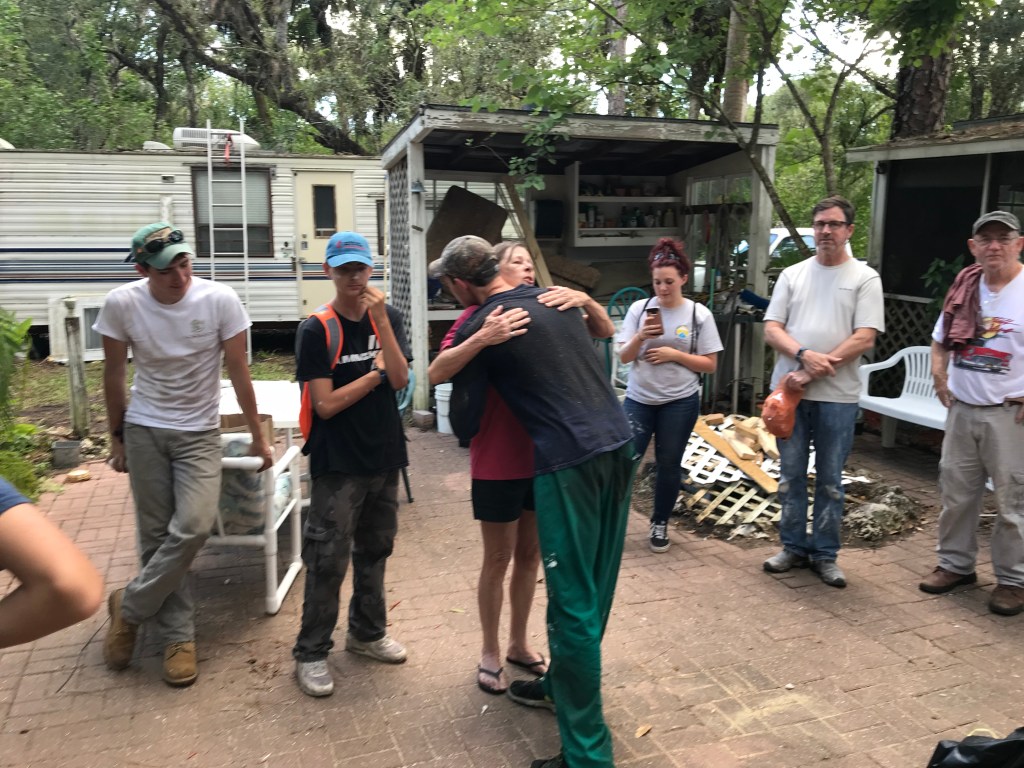 A homeowner hugging a member of the youth mission team that repaired her home